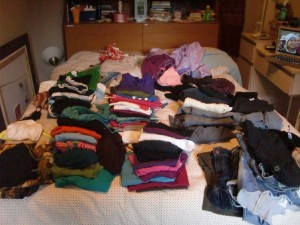 all my summer clothes on my bed, before being bagged