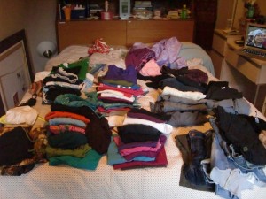 all my summer clothes on my bed, before being bagged