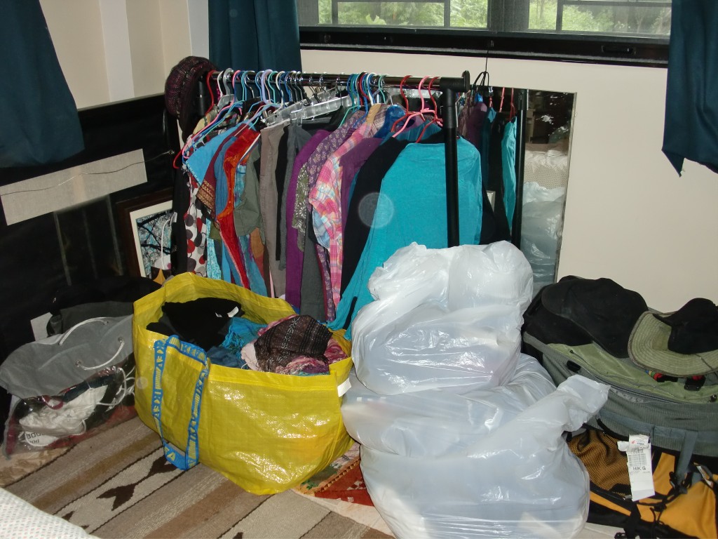 summer clothes on temporary rail and in bags