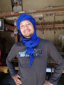 A. in Bedouin scarf