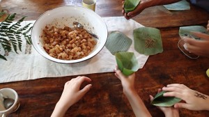 the paste is combined with chicken and wrapped in leaves