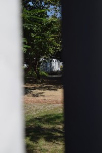 view of the house through the gap in the gate