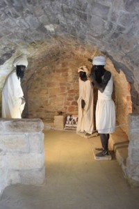 Prayer cell with models replicating Zoroastrians at worship. Zoroastrians worshipped standing up around a fire.